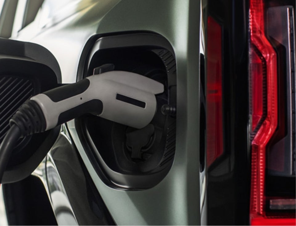 Close up of charging port with charger plugged in on a GMC Hummer EV SUV - Lavery Automotive Sales and Service GMC in Alliance OH